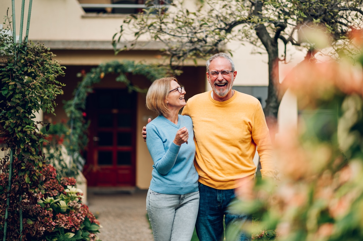 mature-couple-in-front-of-their-new-home Sun City Summerlin Reverse Mortgage